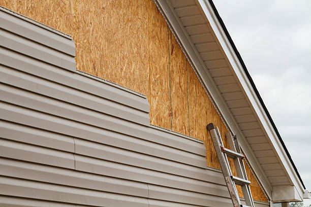 Professional Storm Damage Siding Repair technician working in Laurel, IN